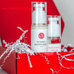 Two skincare products, 'Pumpkin Moisturizer' and 'Soothing Serum', on a red surface with decorative paper.